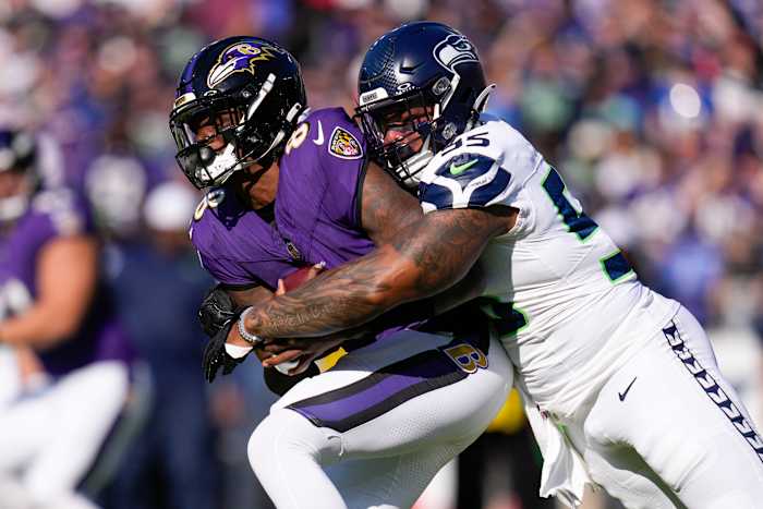 Seattle Seahawks defensive end Dre'Mont Jones (55) sacks Baltimore Ravens quarterback Lamar Jackson (8) during the first half at M&T Bank Stadium.